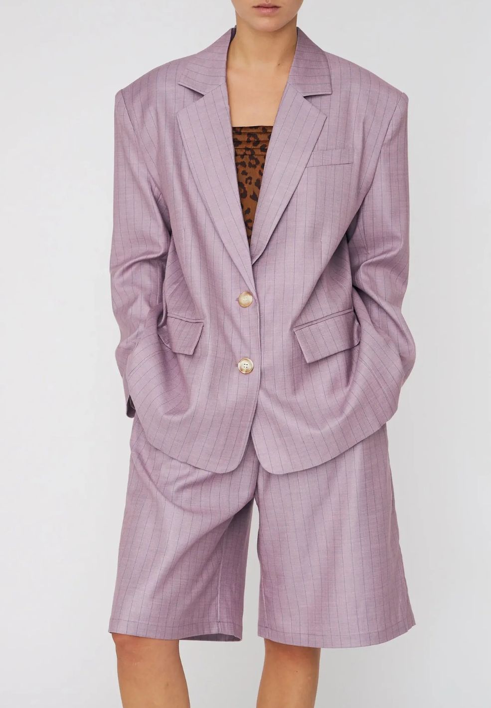 Person wearing a lavender suit with a white background