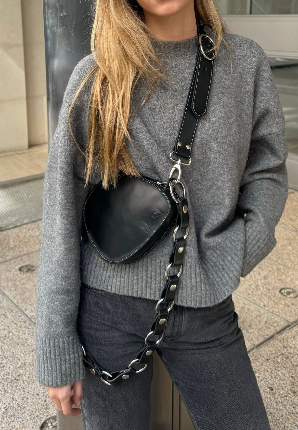 Model wearing the MAS1 Trotter Black Crossbody Bag styled as a crossbody with the long circular chain strap
